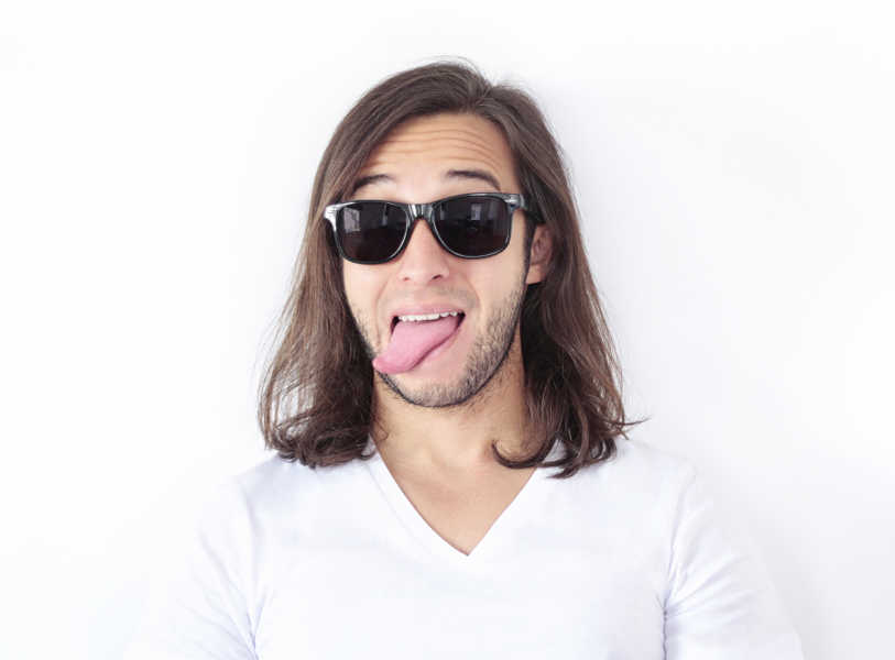 Long-haired man sticking his tongue out